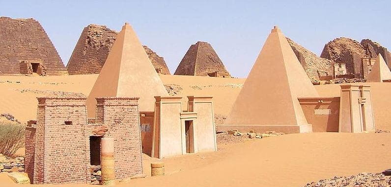 Rows of steep ancient pyramids rising from the desert sand at Meroë, Sudan