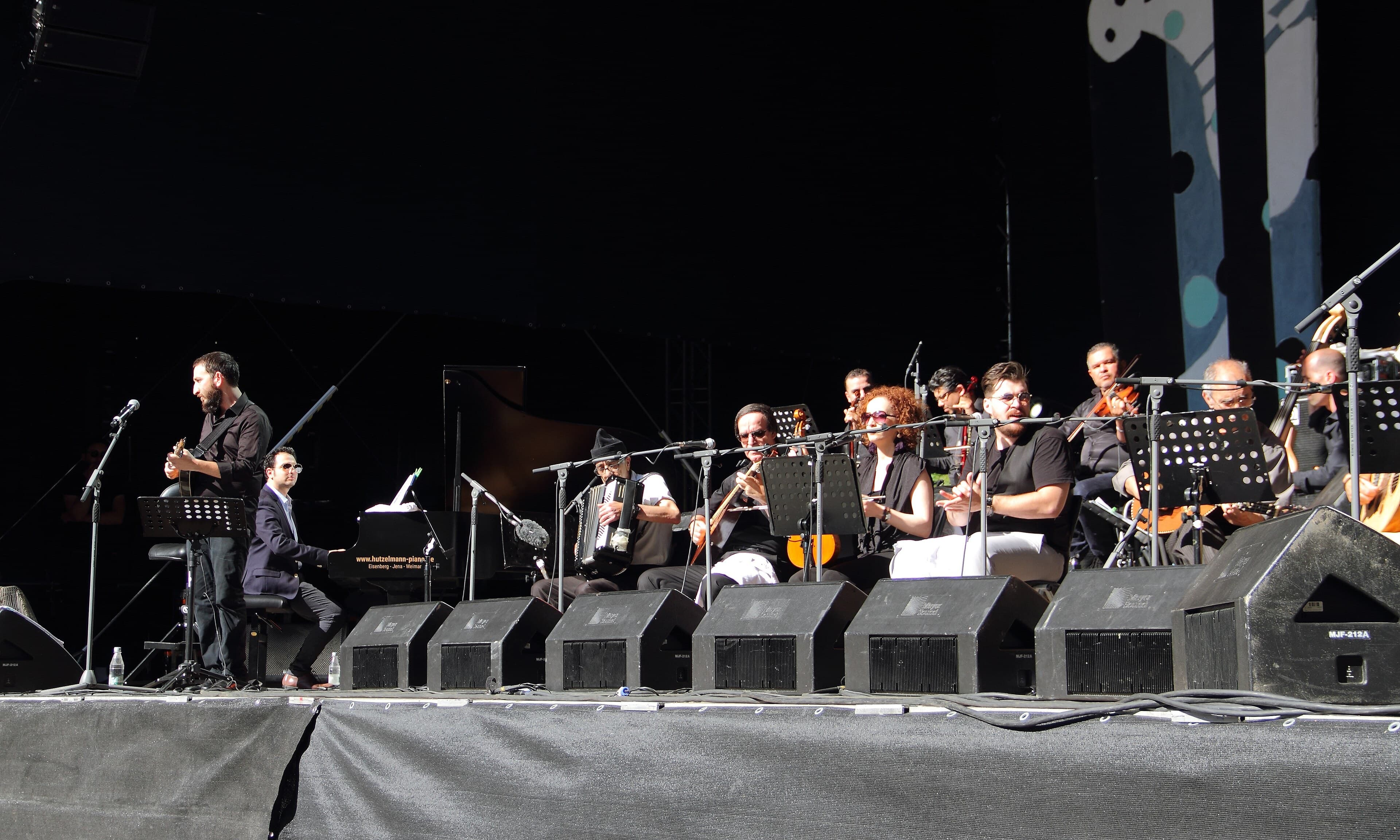 Chaabi musicians playing mandole, lute and small drums together in a caf茅 performance
