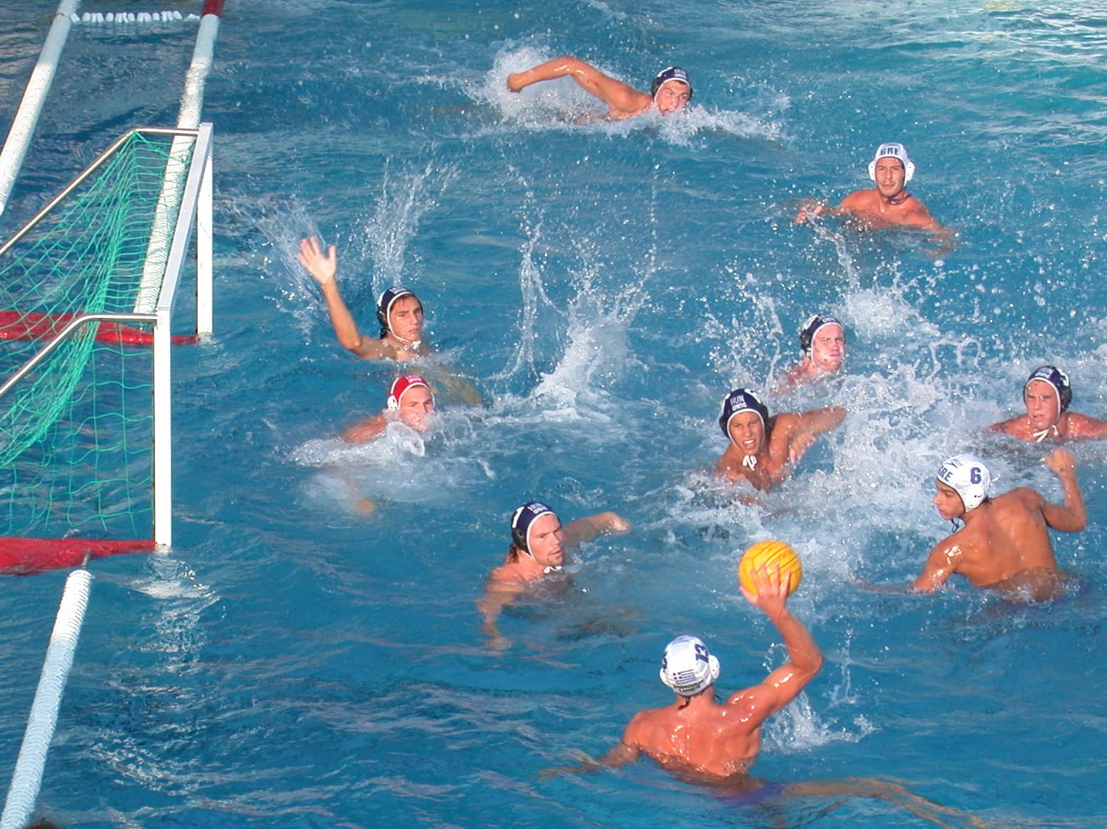 Hungarian water polo players competing in a pool during a match