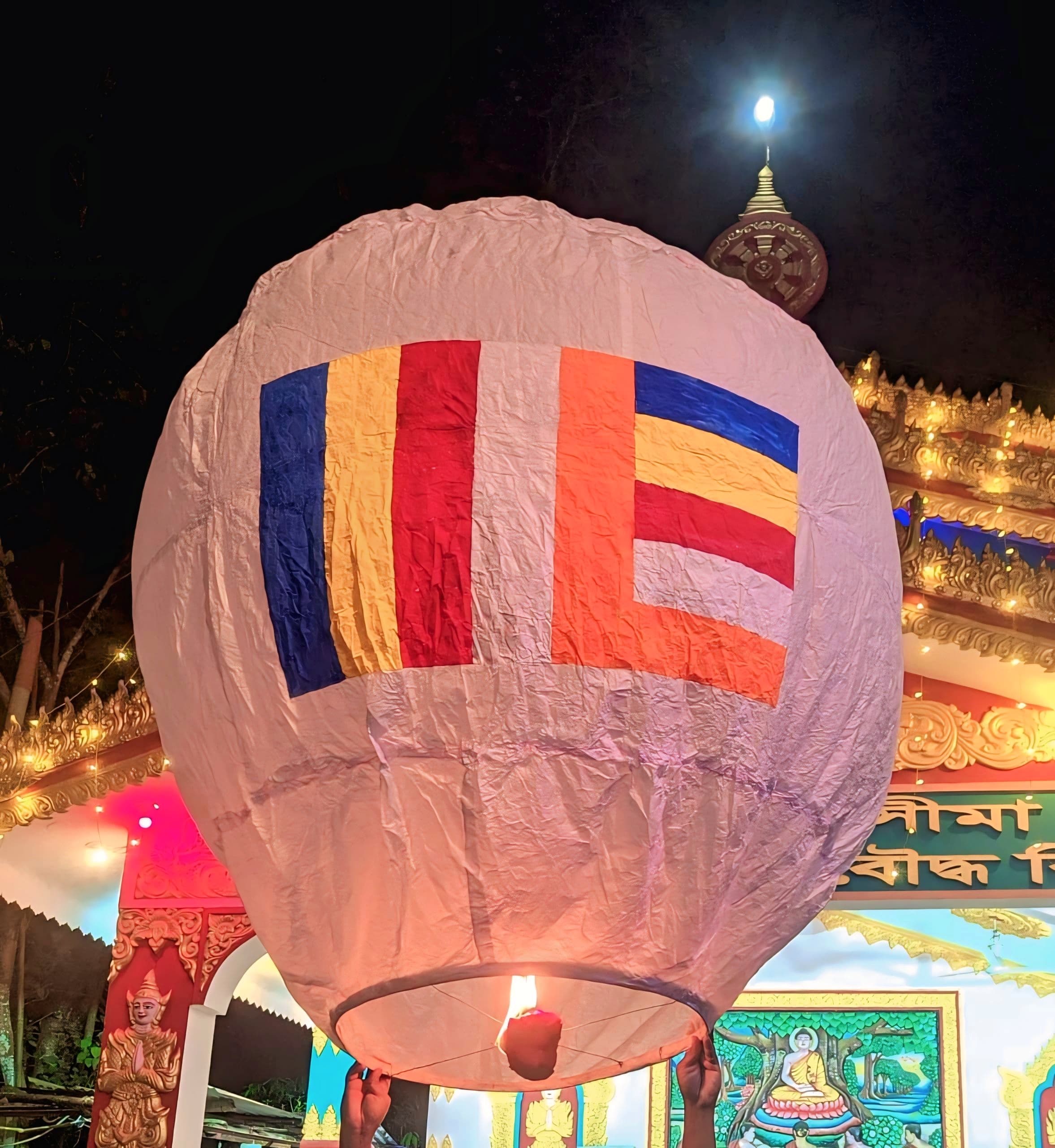 Glowing paper lanterns rising into the night sky over Pingxi
